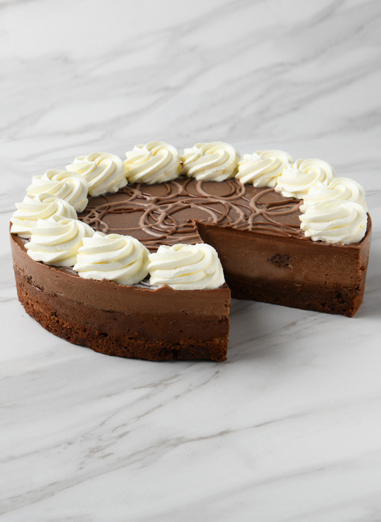 A slice of Triple Chocolate Cheesecake made with Ghirardelli